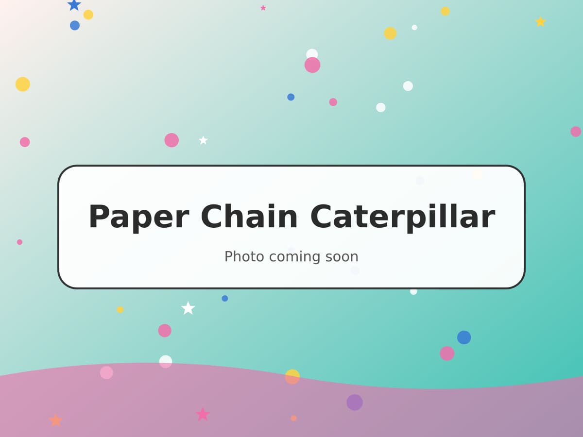A long green and yellow paper chain caterpillar with googly eyes and pipe cleaner antennae