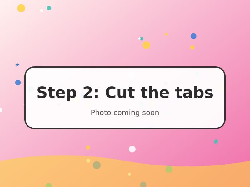 Scissors cutting pairs of slits into folded card